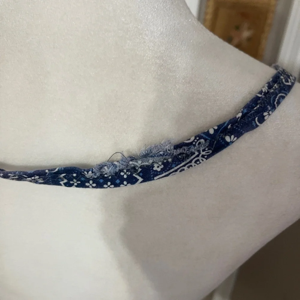 Vintage medium wash light weight ruffled denim apron with embroidered pocket.